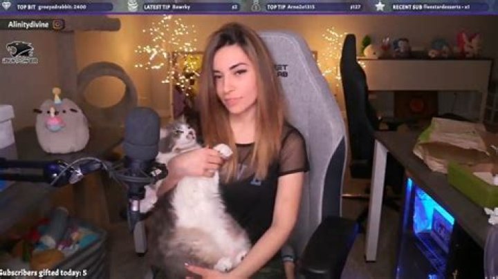 Alinity Divine feeding her cat some Vodka