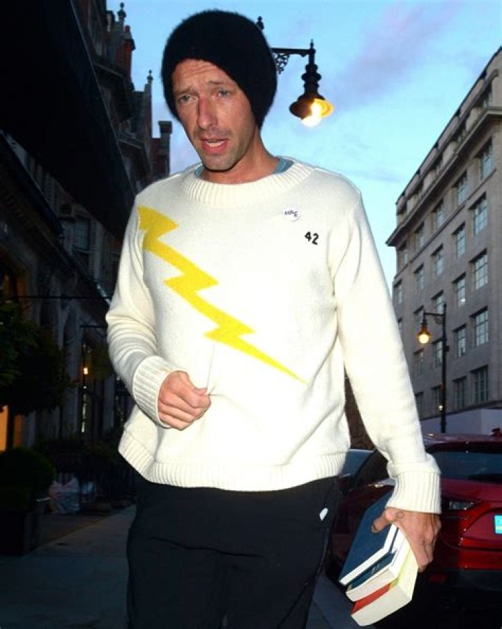 Chris Martin pictured at Scotts Mayfair with a bunch of books
