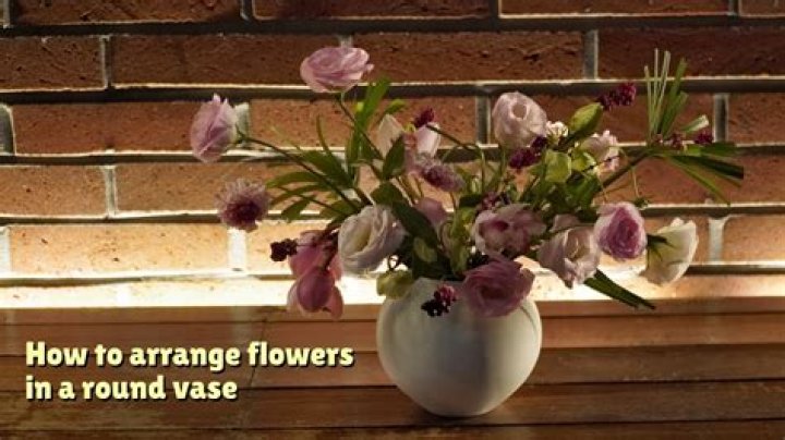 How do you arrange flowers in a wide mouth vase?
