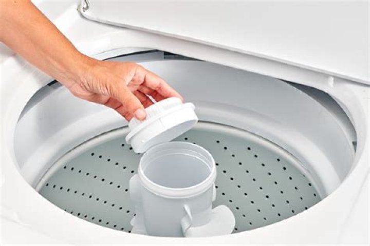 How do you remove the agitator from an LG washing machine?